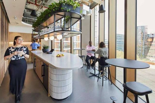 Boardroom configured for hybrid meetings, screens live