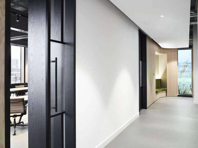 Level 8 corridor with black oak framing and timber-lined nook