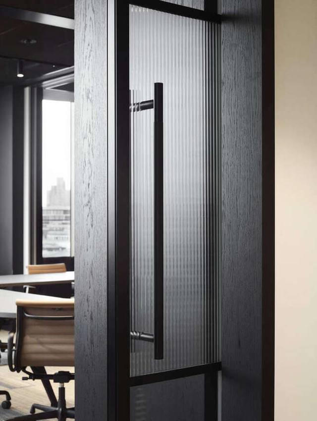 Black oak pocket door with fluted glass and knurled pull