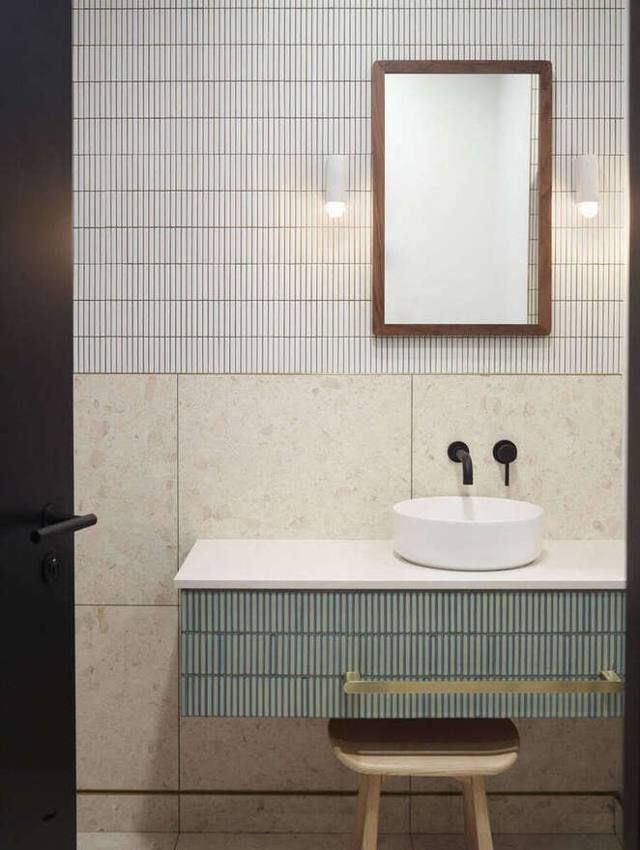 Washroom with kit-kat tile, terrazzo and brass detail