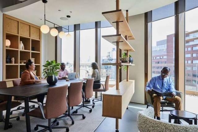 Small meeting room off the working floor, screen live
