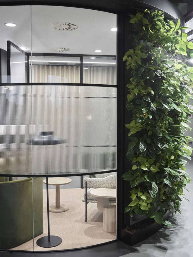 Reception with abstract painting and curved oak joinery