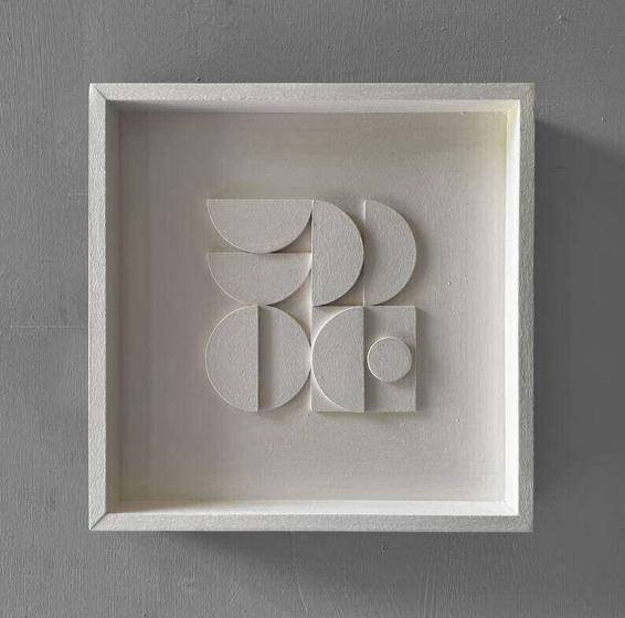 Handmade white geometric plaster relief in a box frame
